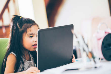 Technology and early education. Child use laptop for fun and learning.の写真素材