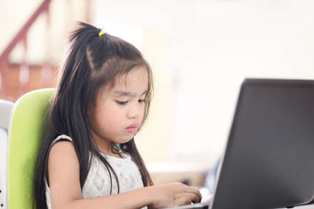 Technology and early education. Child use laptop for fun and learning.の写真素材