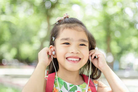 Asian girl using headphone for listen music by smartphoneの写真素材