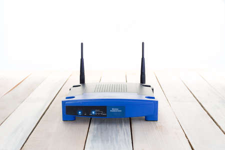 closeup of a wireless router on wood floorの写真素材