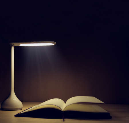 Office desk with Led lamp and paperwork stackの写真素材