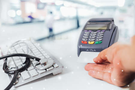 blurred image of counter services in hospitals and  paying with a credit card and using a terminal...
