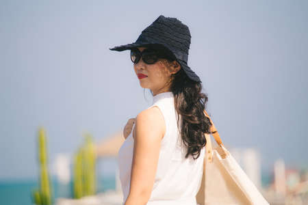 Portrait of happy young woman at beautiful water on a tropical beachの写真素材
