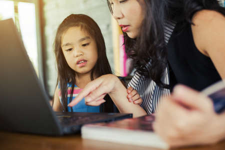 mother and daughter using laptopの写真素材