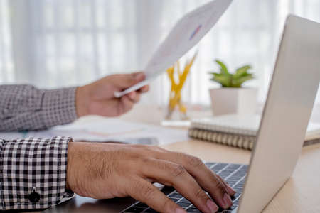 Businessman's hands  use laptop on on office tableの写真素材