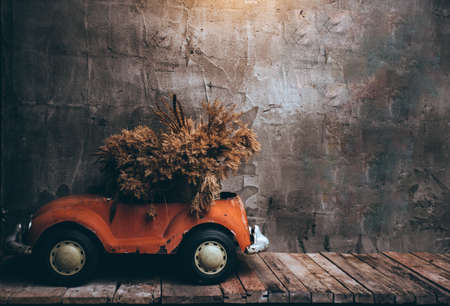 Retro cars on wooden table and Texture old wall backgroundの写真素材