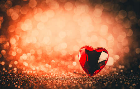 ring Hearts on Red bokeh textured glitter background.Valentines day concept.
の写真素材