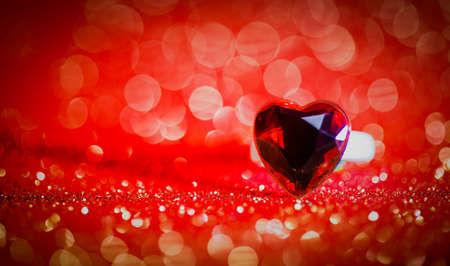 ring Hearts on Red bokeh textured glitter background.Valentines day concept.
の写真素材