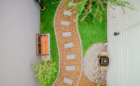 Top view aerial photo from flying drone of Stone walkway winding in garden 
の写真素材