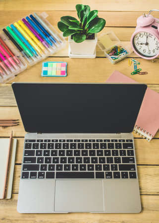 Office workplace with with laptop, reports and pencils on wooden desk tableの写真素材