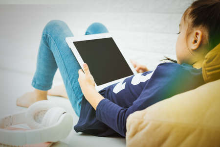 Wireless router and kids using a Tablet in home. router wireless broadband home laptop computer phone wifi conceptの写真素材