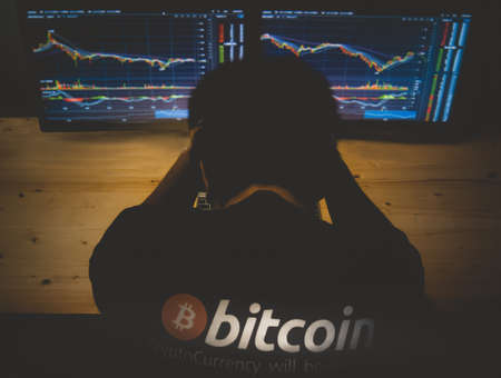 Despair man on down stock bitcoin graph market background.の写真素材