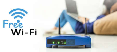 Wireless router and kids using a laptop in hotel. router wireless broadband home laptop computer phone free wifi conceptの写真素材