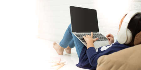 Wireless router and kids using a laptop in home. router wireless broadband home laptop computer phone wifi conceptの写真素材