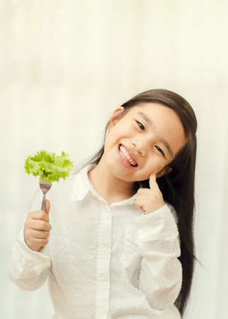 Asian cute  girl eats fresh salad  ,healthy eating conceptの写真素材