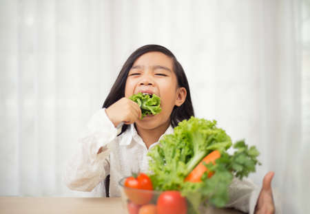 Asian cute  girl eats fresh salad  ,healthy eating conceptの写真素材
