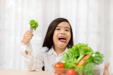 Asian cute  girl eats fresh salad  ,healthy eating conceptの写真素材