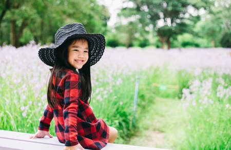Portrait of beautiful asian child feel happy green backgroundの写真素材