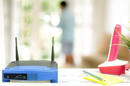 closeup of a wireless router on living room at home with a window in the backgroundの写真素材
