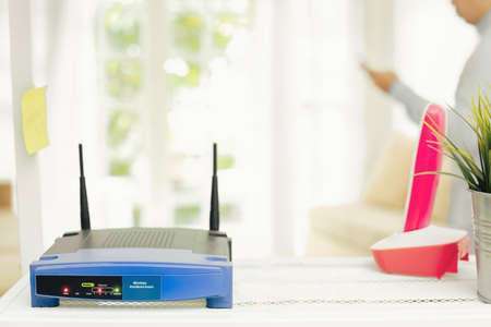 closeup of a wireless router on living room at home with a window in the backgroundの写真素材
