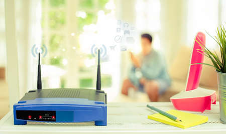 closeup of a wireless router on living room at home with a window in the backgroundの写真素材