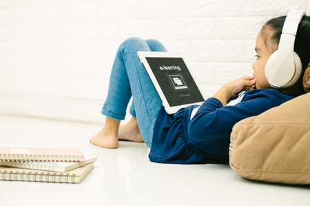 asian child asian child using laptop with inscription on screen e-learning . Online education,e-learning.の写真素材