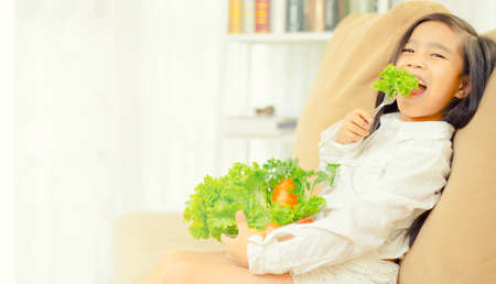 Asian cute  girl eats fresh salad  ,healthy eating conceptの写真素材