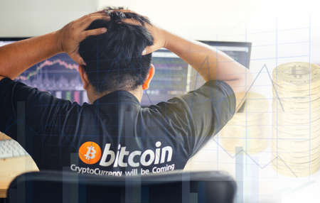 Despair man on down stock bitcoin graph market background.の写真素材