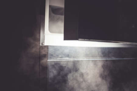 opening a refrigerator door , cold smokeの写真素材
