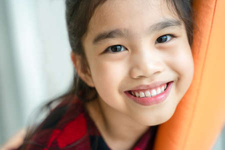 Asian  little girl  smiling with perfect smile and white teeth in dental careの写真素材
