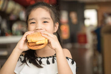 asian Children eat chicken cheese Hamburger Food Courtの写真素材