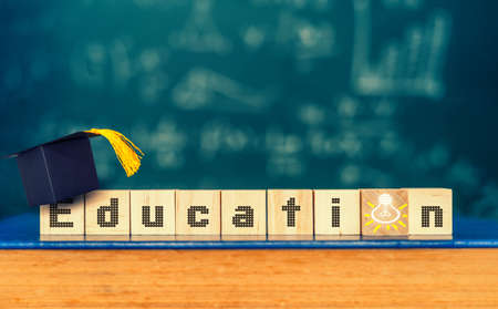 Cubes with word " education " and graduation hat on cubes , education conceptの写真素材