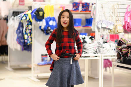 Happy child girl try on outfitsの写真素材