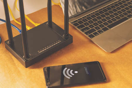 flat lay Office table with wifi router, computer and supplies top view