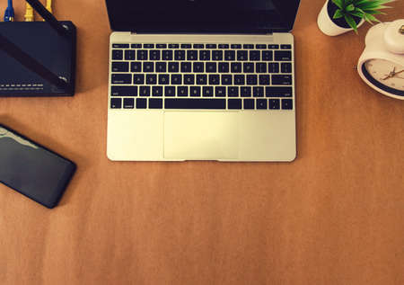 flat lay Office table with wifi router, computer and supplies top view