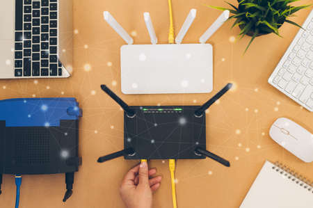 flat lay Office table with wifi router, computer and supplies top view