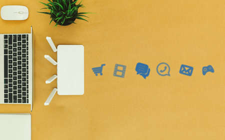 flat lay Office table with wifi router, computer and supplies top viewの写真素材