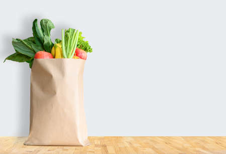 Paper bag with healthy food over white backgroundの写真素材