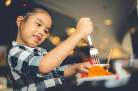Asian Children Eating Fried Chicken Food Courtの写真素材