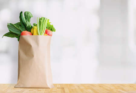 Paper bag with healthy food over white backgroundの写真素材