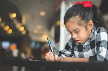 young asia reading book in library , University girl , education conceptの写真素材