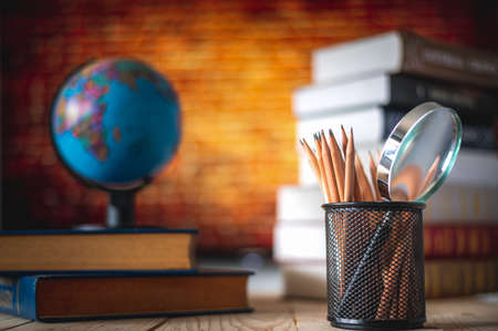Textbooks,  globe and pencils on a wooden background. Educational backgroundの写真素材