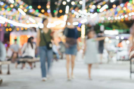 Abstract blur image of flea market and people at night with bokeh for backgroundの写真素材