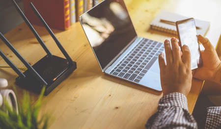 Young man Connecting router wifi On smartphone  for Internet and social mediaの写真素材