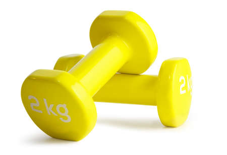 Two yellow  dumbbells isolated on white backgroundの写真素材