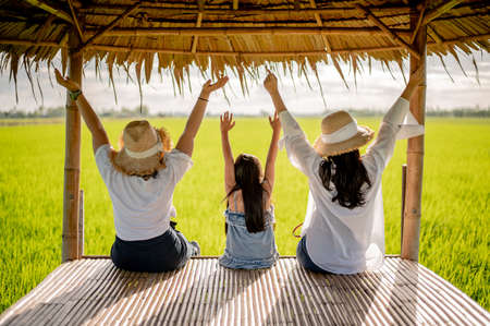 Happy group of women on the sunset in nature in summer with open handsの写真素材