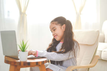 Back to School. asian Little girl using his laptopの写真素材