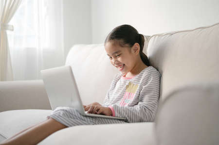 Back to School. asian Little girl using his laptopの写真素材