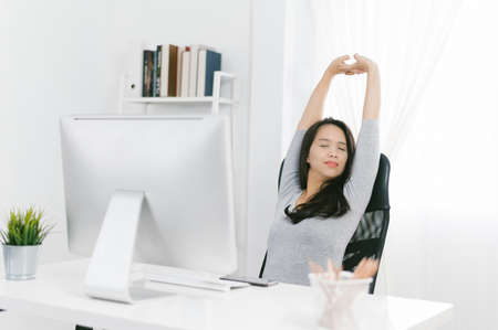 Business woman relaxing and sitting on an home office chair. Asian ladyの写真素材