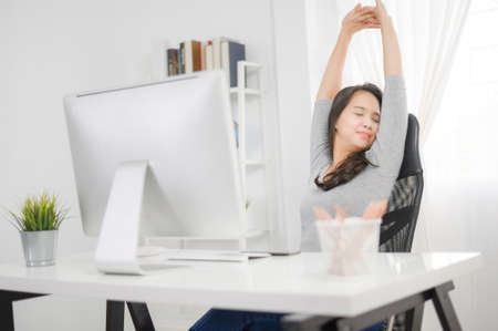 housewife relaxing and sitting on an home office chair.Asianの写真素材